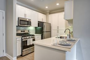 North Hollywood apartment for rent - A kitchen with white cabinets and a counter.