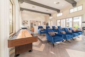 Las Vegas apartment for rent - A pool table is in the middle of a room with blue chairs.