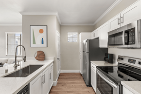 Las Vegas apartment for rent - A kitchen with white cabinets and stainless steel appliances.