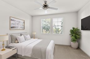 Santa Fe Springs apartment for rent - A bedroom with a bed, a ceiling fan, a nightstand with a lamp, a potted plant, and a painting on the wall.