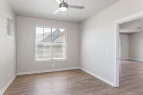 Portland apartment for rent - A room with a ceiling fan and a window with blinds.
