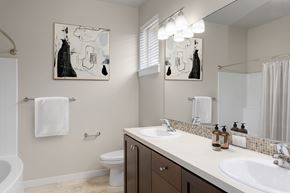 Portland apartment for rent - A bathroom with a toilet, sink, and mirror.