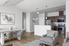 Portland apartment for rent - A modern dining room with a white table and grey chairs.