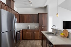 Portland apartment for rent - A modern kitchen with wooden cabinets and stainless steel appliances.
