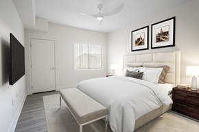 Henderson apartment for rent - A bedroom with a large bed and a flat screen TV mounted on the wall.