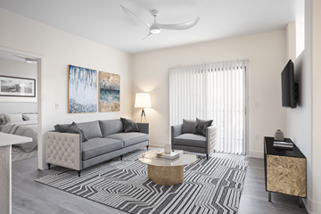 Henderson apartment for rent - A living room with a grey couch, a black and white striped rug, and a painting on the wall.