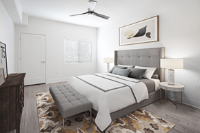 Henderson apartment for rent - A bedroom with a large bed and a bench in front of it.