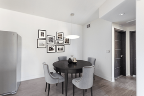 Henderson apartment for rent - A modern dining room with a round table and grey chairs.