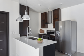 Henderson apartment for rent - A modern kitchen with a stainless steel refrigerator and a white countertop.