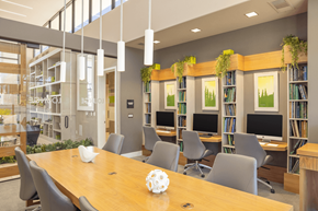 Las Vegas apartment for rent - A conference room with a long table, chairs, and a bookshelf with greenery.