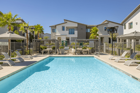 Las Vegas apartment for rent - A swimming pool in front of a row of houses.