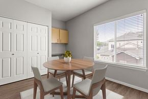 Puyallup apartment for rent - A dining room with a round wooden table and four chairs.