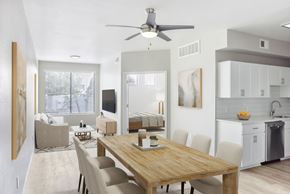 Phoenix apartment for rent - A modern dining room with a wooden table and chairs.