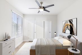Phoenix apartment for rent - A bedroom with a bed, a ceiling fan, and a painting on the wall.