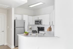 Phoenix apartment for rent - A kitchen with white cabinets and appliances.