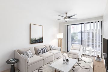Phoenix apartment for rent - A living room with a white couch, a coffee table, and a painting on the wall.