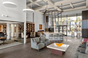 Henderson apartment for rent - A modern living room with a glass wall and a grey sofa.