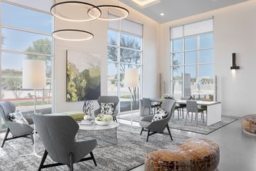 Phoenix apartment for rent - A modern living room with grey chairs and a large window.
