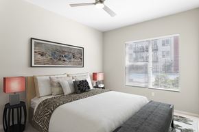 Phoenix apartment for rent - A bedroom with a large bed, two lamps, and a ceiling fan.