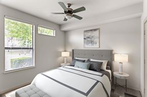 Nashville apartment for rent - A bedroom with a large bed and a ceiling fan.