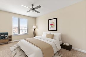 Jacksonville apartment for rent - A bedroom with a large bed and a ceiling fan.