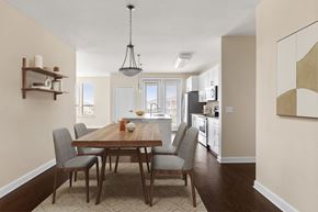 Jacksonville apartment for rent - A dining room with a wooden table and chairs.