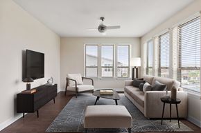 Jacksonville apartment for rent - A living room with a television, a couch, a chair, a coffee table, and a rug.