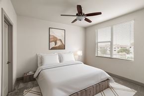 Tempe apartment for rent - A bedroom with a large bed and a ceiling fan.