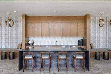 Tempe apartment for rent - A modern kitchen with wooden cabinets and a dark countertop.