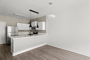 Las Vegas apartment for rent - A kitchen with a white counter and a refrigerator.
