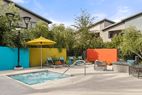 Las Vegas apartment for rent - A pool area with a yellow umbrella and blue water.