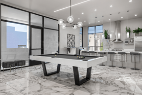 Henderson apartment for rent - A modern kitchen with a pool table in the middle.