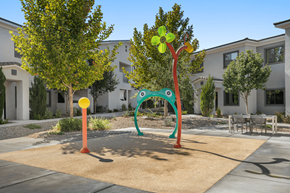 Henderson apartment for rent - A playground with a green frog and a red and orange pole.
