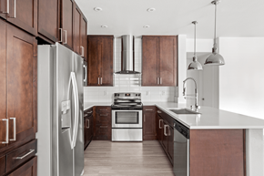 Las Vegas apartment for rent - A modern kitchen with wooden cabinets and stainless steel appliances.