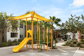 Las Vegas apartment for rent - A playground with a yellow slide and a green canopy.