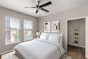 Irving apartment for rent - A bedroom with a large bed and a ceiling fan.