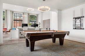 Irving apartment for rent - A pool table is in the middle of a room with a white ceiling and a window.