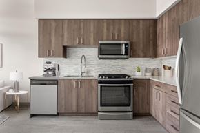 Portland apartment for rent - A modern kitchen with wooden cabinets and stainless steel appliances.