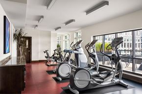 Portland apartment for rent - A gym with a row of stationary bikes and a painting on the wall.