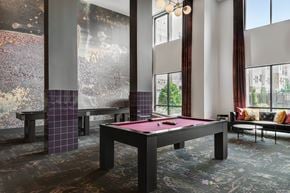 Fort Worth apartment for rent - A pool table in a room with a view of the city.