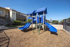 Santa Clarita apartment for rent - A playground with a blue slide and a blue canopy.