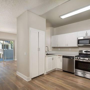 Santa Clarita apartment for rent - A kitchen with white cabinets and stainless steel appliances.