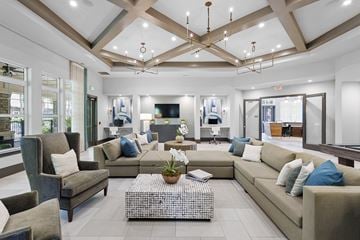Tampa apartment for rent - A spacious living room with a variety of seating options and a coffee table in the center.