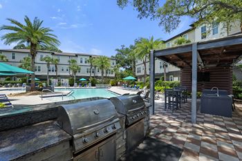 Outdoor summer kitchen with grills, sink & refrigerator