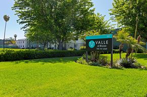 Escondido apartment for rent - A green sign with the word "Valle" on it is in front of a building.