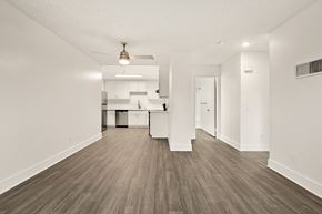 Ramona apartment for rent - A kitchen with white cabinets and a wooden floor.