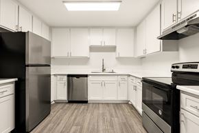 Ramona apartment for rent - A modern kitchen with black appliances and white cabinets.