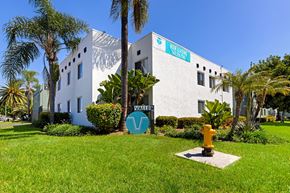 Escondido apartment for rent - A white building with a blue sign that says "Not So Fast" on it.