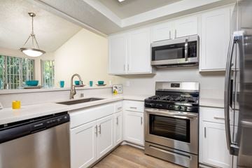 Los Angeles apartment for rent - A kitchen with white cabinets and stainless steel appliances.