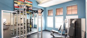 Grand Terrace apartment for rent - A gym with a blue wall and a variety of equipment.